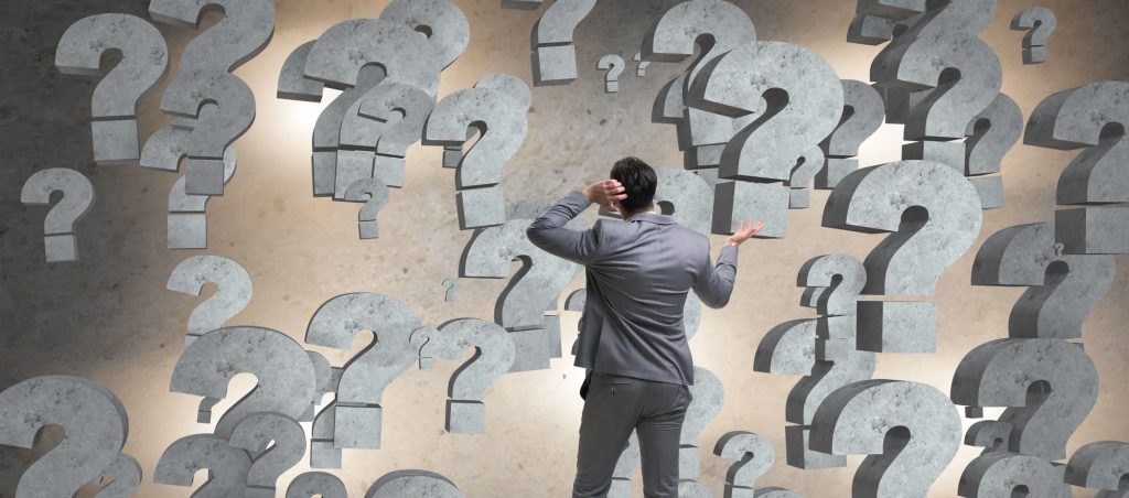 Businessman facing questions in business