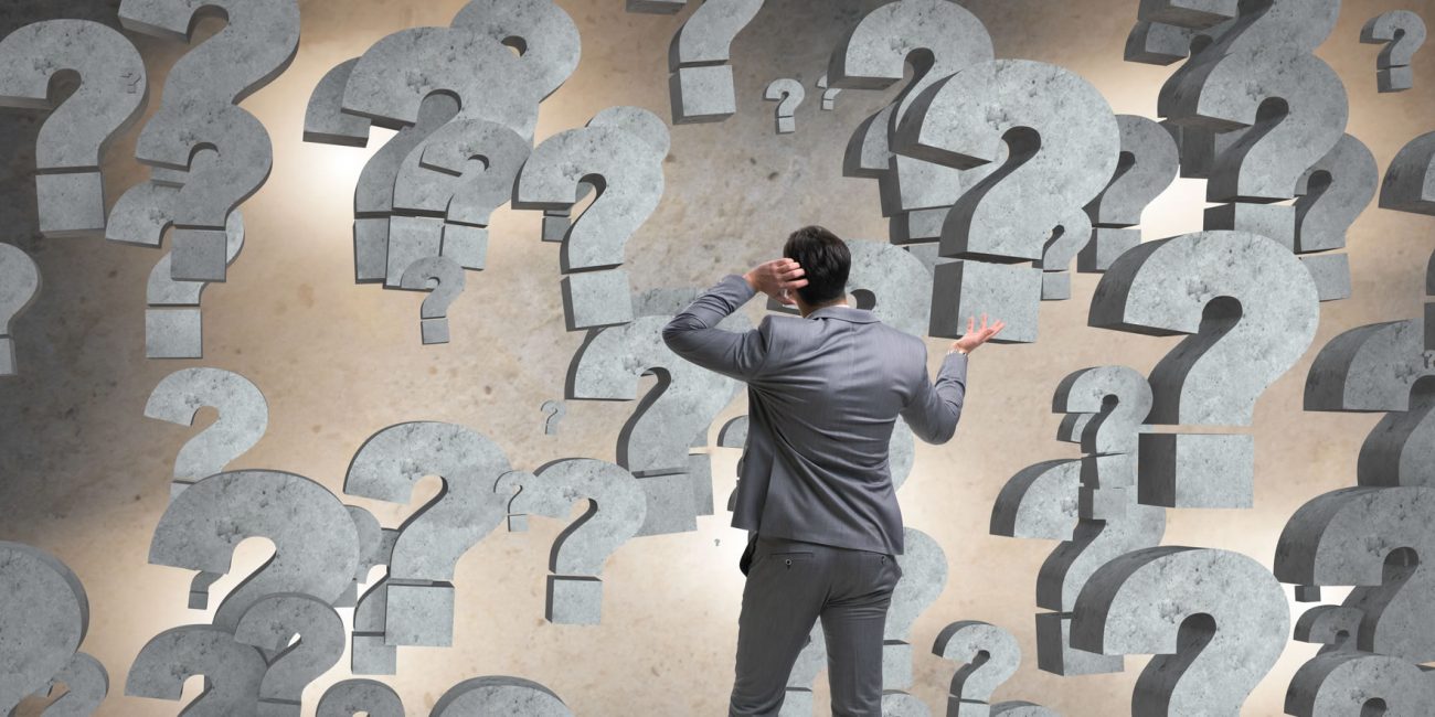 Businessman facing questions in business