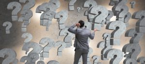 Businessman facing questions in business